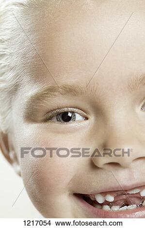 Picture - A happy young girl with missing front teeth. Fotosearch