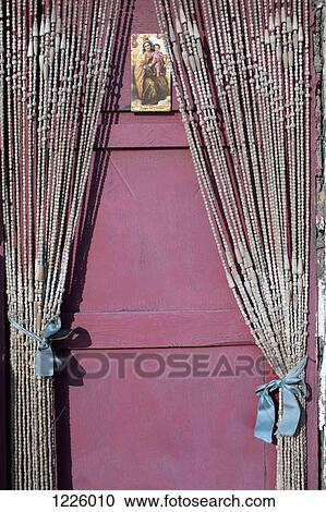 A holy card with the Virgin Mary and the baby Jesus hanging on a door with beaded curtains View Large Photo Image Stock Image - A holy card with the Virgin Mary and the baby Jesus hanging on a door with beaded curtains. Fotosearch