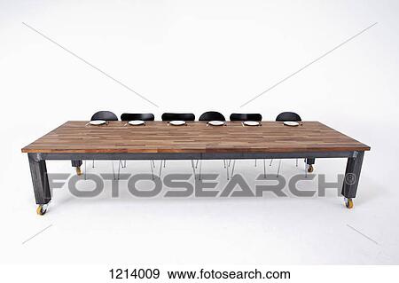 A large wood table with six chairs and six empty place settings View Large Photo Image Stock Photo - A large wood table with six chairs and six empty place settings. Fotosearch