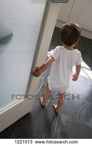 A little boy standing just inside a doorway View Large Photo Image Stock Image - A little boy standing just inside a doorway. Fotosearch
