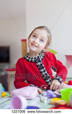 A little girl playing at a table with toys on it View Large Photo Image Stock Photograph - A little girl playing at a table with toys on it. Fotosearch