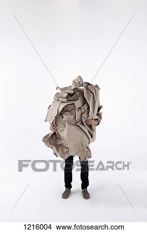 Picture - A man carrying an impossibly large ball of crumpled construction paper. Fotosearch