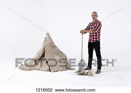 A man standing by dug up construction paper rock, next to an artificial paper boulder View Large Photo Image Stock Image - A man standing by dug up construction paper rock, next to an artificial paper boulder. Fotosearch