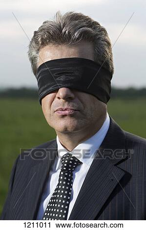 A mature businessman blindfolded, portrait View Large Photo Image Stock Image - A mature businessman blindfolded, portrait. Fotosearch