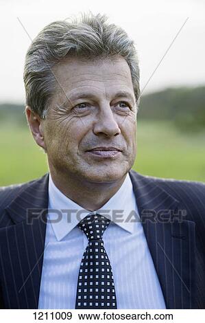 A mature businessman looking thoughtfully away View Large Photo Image Stock Photo - A mature businessman looking thoughtfully away. Fotosearch