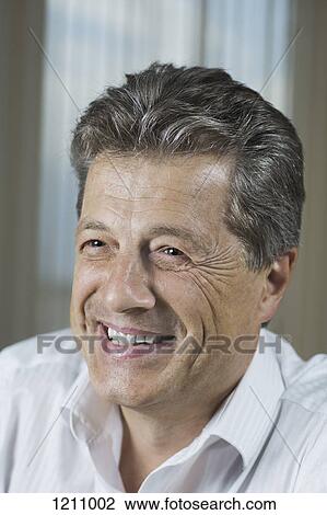 A mature man grinning happily while looking away View Large Photo Image Stock Image - A mature man grinning happily while looking away. Fotosearch