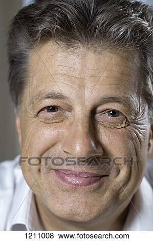 A mature man smiling into the camera View Large Photo Image Stock Photo - A mature man smiling into the camera. Fotosearch
