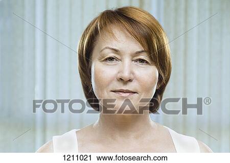 A mature woman looking serenely into the camera View Large Photo Image Stock Image - A mature woman looking serenely into the camera. Fotosearch