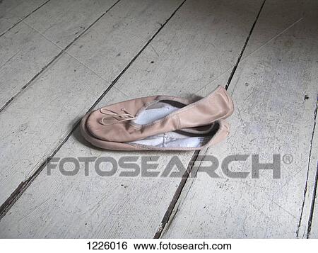 A pair of worn ballet shoes on a hardwood floor View Large Photo Image Stock Photograph - A pair of worn ballet shoes on a hardwood floor. Fotosearch