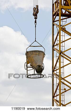 A piece of construction equipment being raised by a crane View Large Photo Image Stock Photo - A piece of construction equipment being raised by a crane. Fotosearch