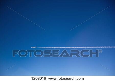 A plane and vapor trails in the sky View Large Photo Image Stock Photo - A plane and vapor trails in the sky. Fotosearch