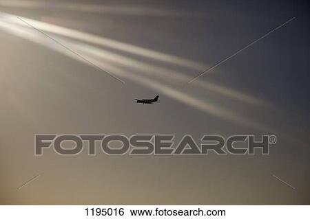 Stock Photograph - A plane flying in the sky. Fotosearch