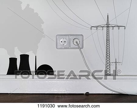 Stock Image - A plug in an outlet in between decals of a nuclear power station and electricity pylons. Fotosearch