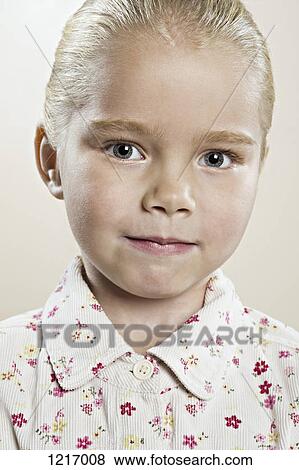 A serene young girl wearing a button down shirt with floral pattern View Large Photo Image Stock Photo - A serene young girl wearing a button down shirt with floral pattern. Fotosearch