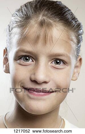 Stock Image - A serenely happy young girl. Fotosearch