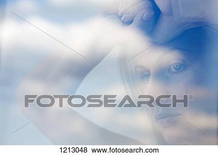 A serious woman looking contemplatively out a window View Large Photo Image Stock Photo - A serious woman looking contemplatively out a window. Fotosearch