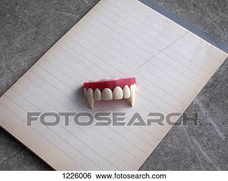 A set of vampire fangs on top of a note pad of lined paper View Large Photo Image Stock Photograph - A set of vampire fangs on top of a note pad of lined paper. Fotosearch