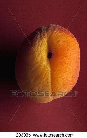 A slightly wrinkled peach on a red background View Large Photo Image Stock Photography - A slightly wrinkled peach on a red background. Fotosearch