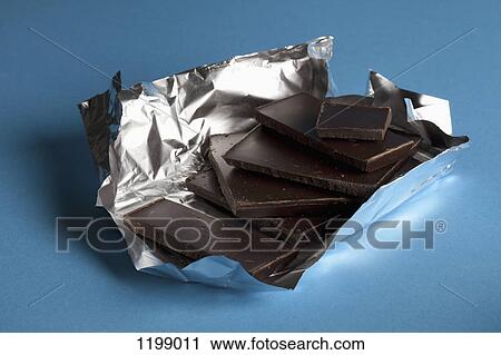 A stack of chocolate in foil packaging View Large Photo Image Stock Image - A stack of chocolate in foil packaging. Fotosearch