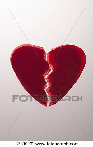 Stock Photo - A stack of red tissue paper broken hearts. Fotosearch