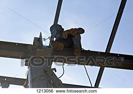 A welder welding steel on a high beam View Large Photo Image Stock Photograph - A welder welding steel on a high beam. Fotosearch