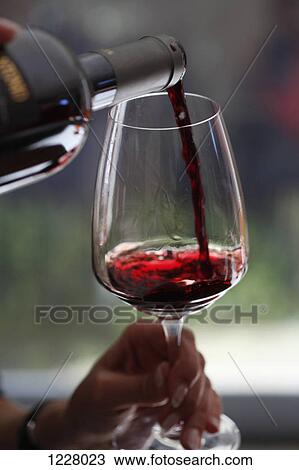 A woman pouring a sampling of red wine at a wine tasting, focus on hands View Large Photo Image Stock Image - A woman pouring a sampling of red wine at a wine tasting, focus on hands. Fotosearch