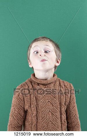 A young boy crossing his eyes looking at his nose View Large Photo Image Stock Photo - A young boy crossing his eyes looking at his nose. Fotosearch