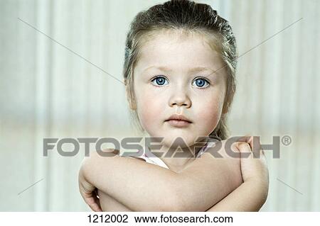 A young girl hugging herself while looking blankly into the camera View Large Photo Image Stock Image - A young girl hugging herself while looking blankly into the camera. Fotosearch