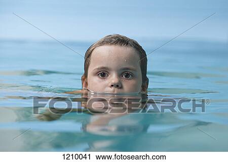 Stock Image - A young girl in a swimming pool, close-up. Fotosearch