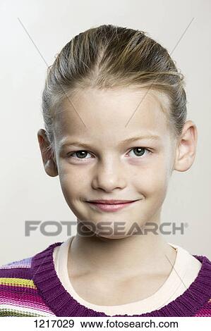 Stock Photo - A young girl looking contentedly into the camera. Fotosearch