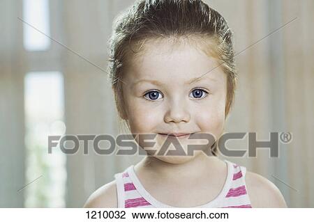 A young girl smiling into the camera View Large Photo Image Stock Image - A young girl smiling into the camera. Fotosearch