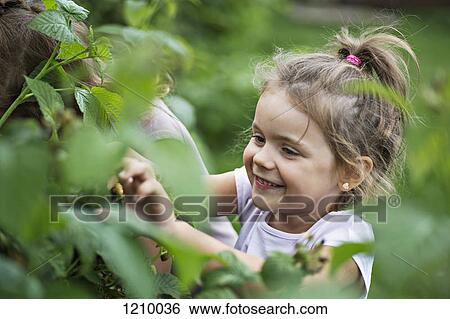 A young grinning young girl standing next to a friend View Large Photo Image Stock Photograph - A young grinning young girl standing next to a friend . Fotosearch