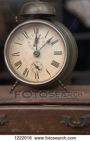 Alarm clock in shop on chest of drawers View Large Photo Image Stock Photograph - Alarm clock in shop on chest of drawers. Fotosearch