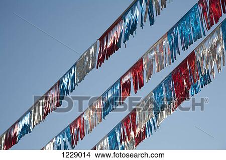 American flag coloured streamers against a clear blue sky View Large Photo Image Picture - American flag coloured streamers against a clear blue sky. Fotosearch