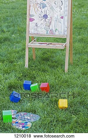 An easel, toy blocks and watercolor paints in the grass of a backyard View Large Photo Image Stock Photo - An easel, toy blocks and watercolor paints in the grass of a backyard. Fotosearch