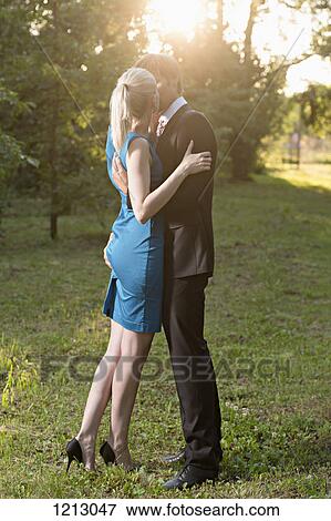 An elegantly dressed man kissing his girlfriend passionately while squeezing her bottom View Large Photo Image Stock Photo - An elegantly dressed man kissing his girlfriend passionately while squeezing her bottom. Fotosearch