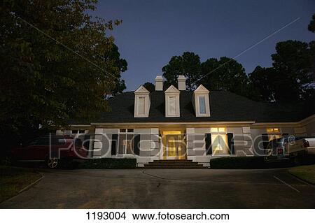 Picture - An illuminated house at night. Fotosearch