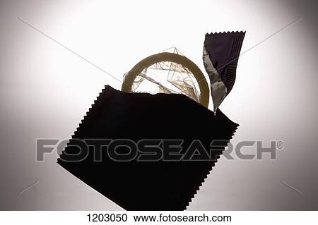 Stock Image - An opened condom wrapper with an unused condom. Fotosearch