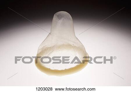 An unused, rolled up condom with the tip sticking up View Large Photo Image Stock Photo - An unused, rolled up condom with the tip sticking up. Fotosearch