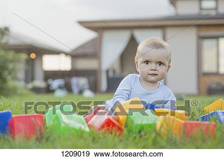 Baby in the garden with building blocks View Large Photo Image Stock Photo - Baby in the garden with building blocks. Fotosearch
