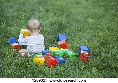 Baby in the garden with building blocks View Large Photo Image Stock Photo - Baby in the garden with building blocks. Fotosearch