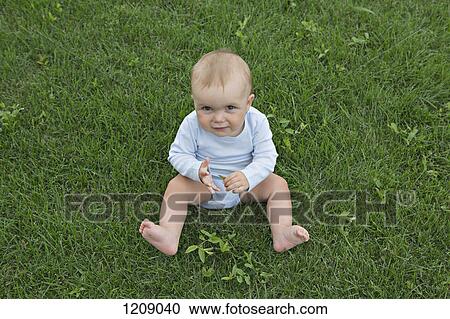 Baby on the grass looking up View Large Photo Image Stock Image - Baby on the grass looking up. Fotosearch
