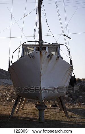 Boat on land in need of repair View Large Photo Image Stock Image - Boat on land in need of repair. Fotosearch