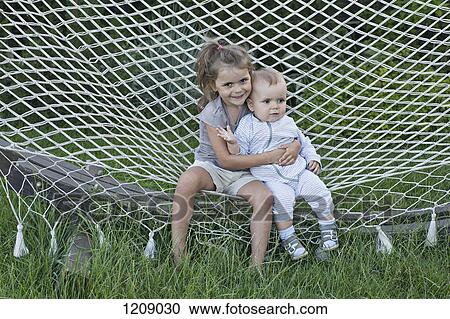 Brother and sister sitting on hammock View Large Photo Image Stock Image - Brother and sister sitting on hammock . Fotosearch