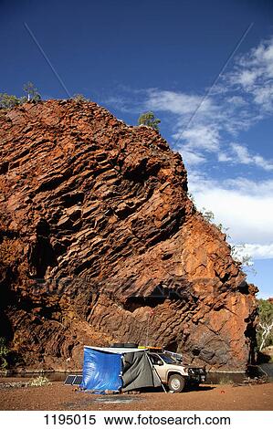 Stock Photography - Camping next to a rock formation. Fotosearch