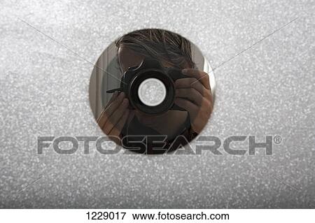 Stock Photo - CD reflecting photographer. Fotosearch