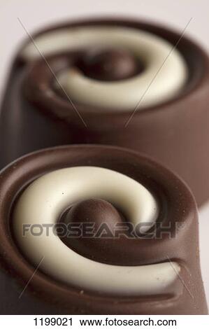 Close-up of two chocolates View Large Photo Image Stock Image - Close-up of two chocolates. Fotosearch