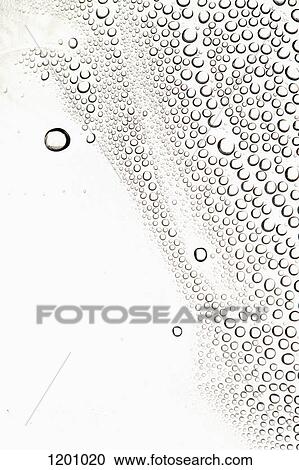 Stock Image - Condensation on a shiny surface making an abstract pattern. Fotosearch