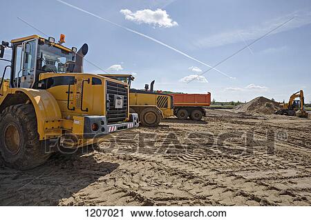 Stock Image - Construction vehicles on work site. Fotosearch