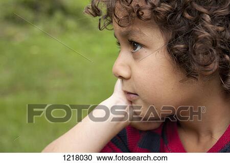 Stock Image - Daydreaming boy. Fotosearch